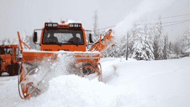  Commercial snow plow clearing parking lots and business areas for safe winter access.
